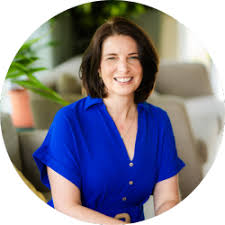 Caroline Green, woman with dark hair wearing blue dress